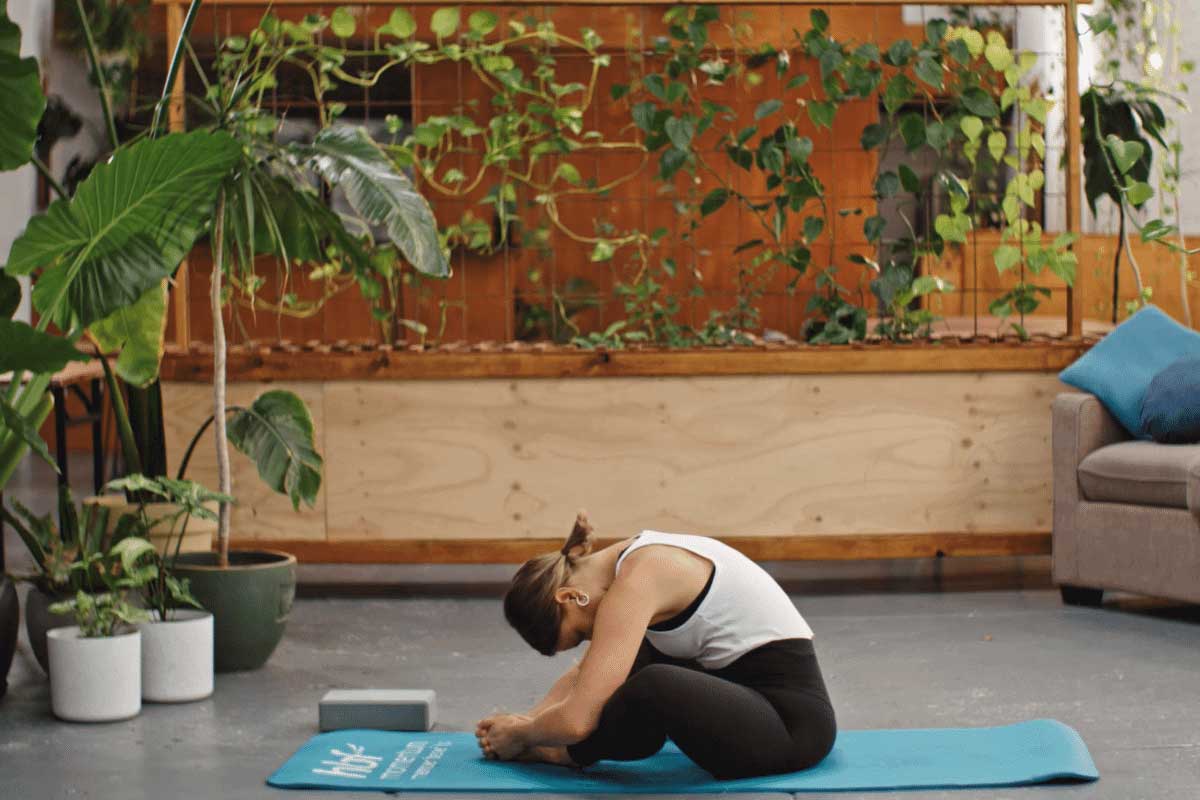 Young woman practising butterfly pose in yoga