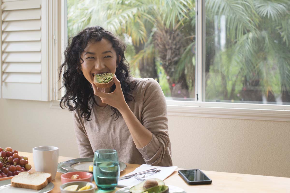 Woman eating a nutritionist avocado toast