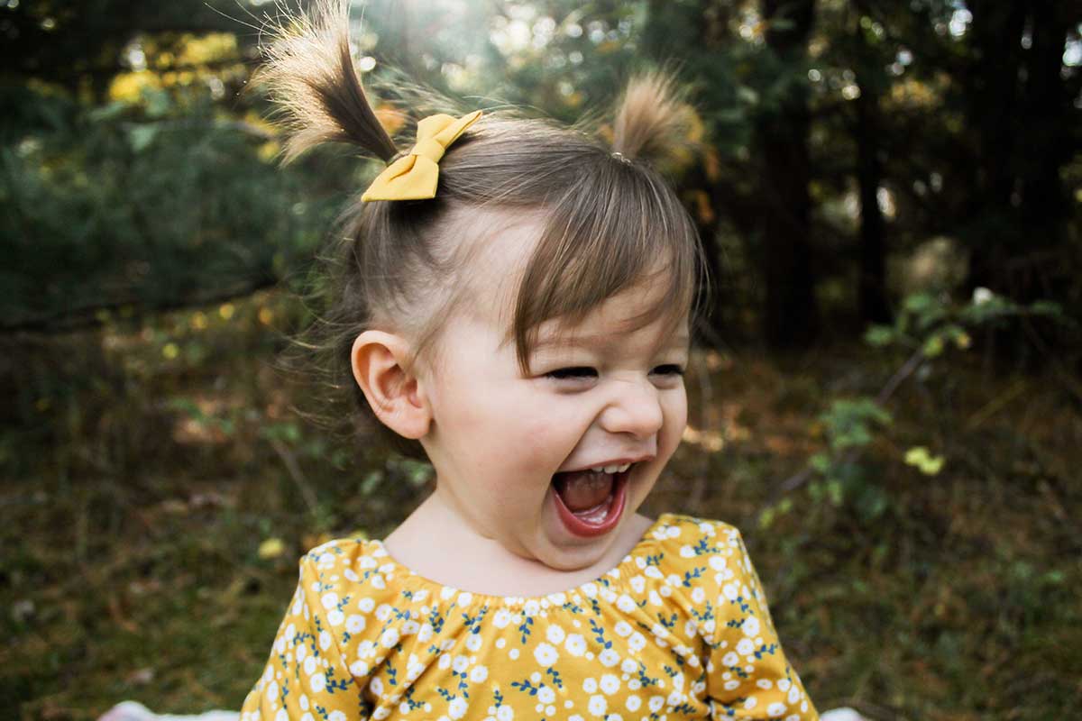 Young girl with baby teeth laughing