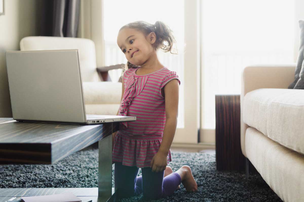 Young girl confused looking at laptop