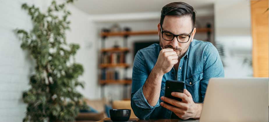 Man researching financial support options on his phone