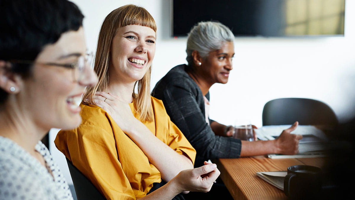 Corporate women at a meeting table