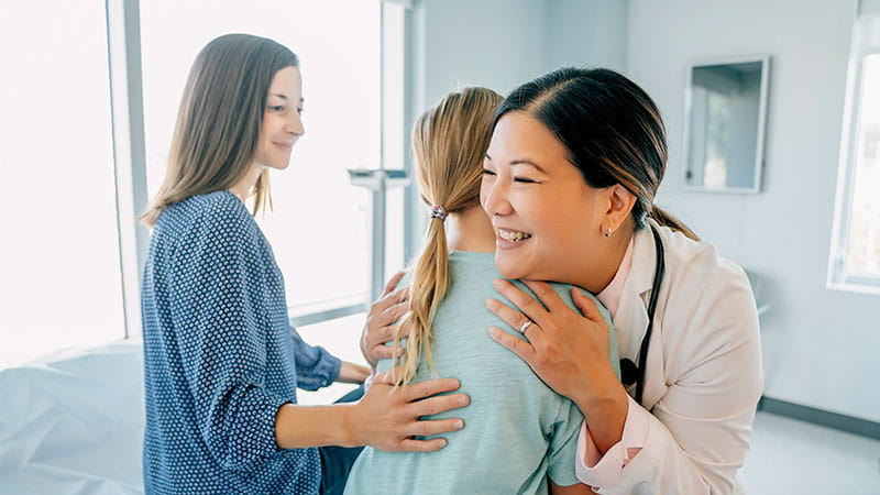 Doctor hugging patient