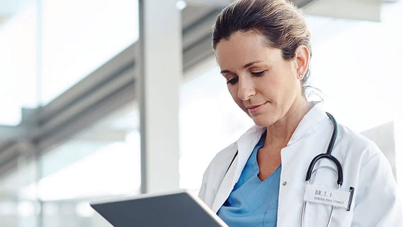 Doctor looking at clipboard
