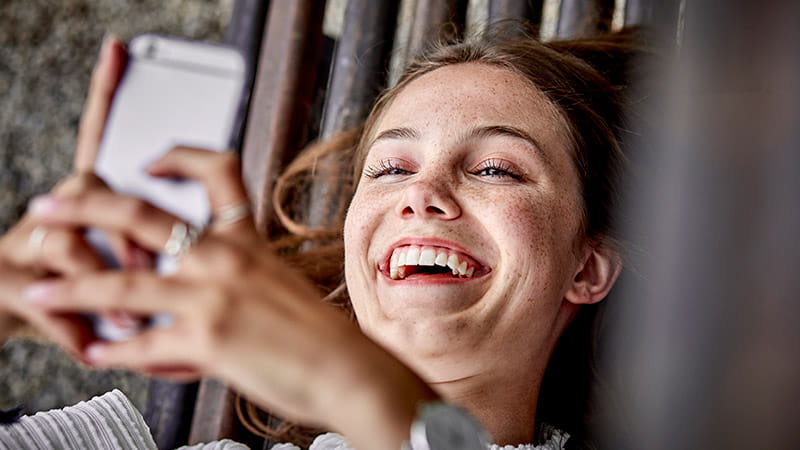 Young woman on phone laughing