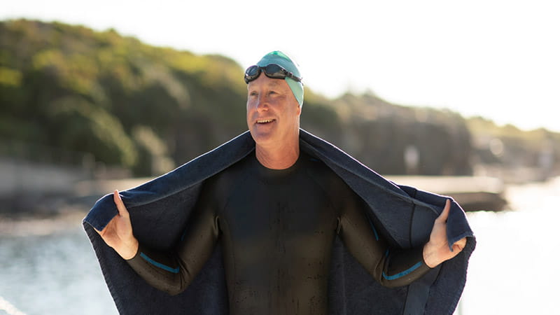 Man in wetsuit with towel