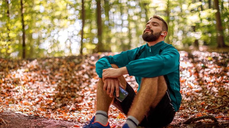 Man sitting down in forrest