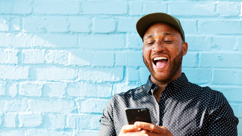 Man smiling on his mobile phone