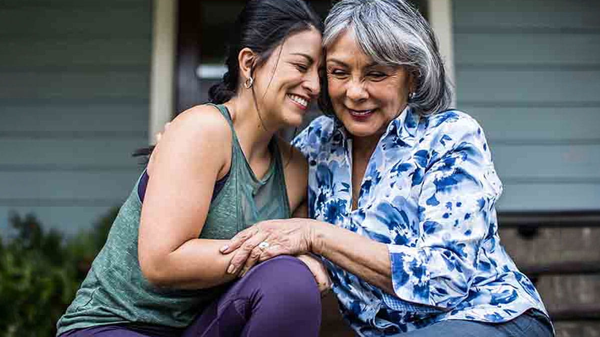Mother and daughter hugging outside
