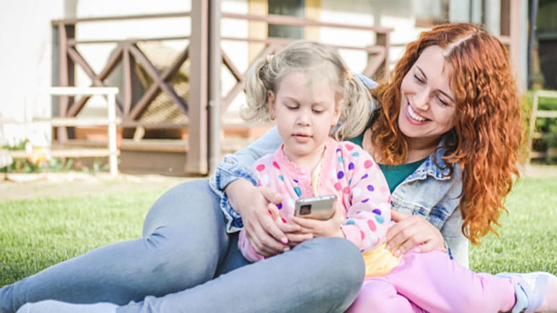 Mother lying grass with child