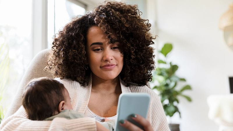 Mum with child looking at phone