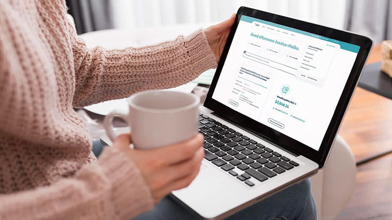 Woman on laptop with tea cup