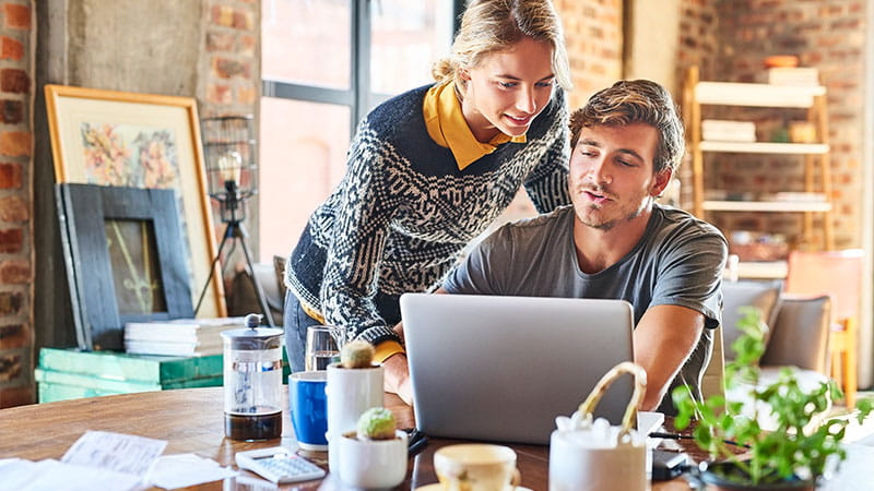 Young couple researching on computer