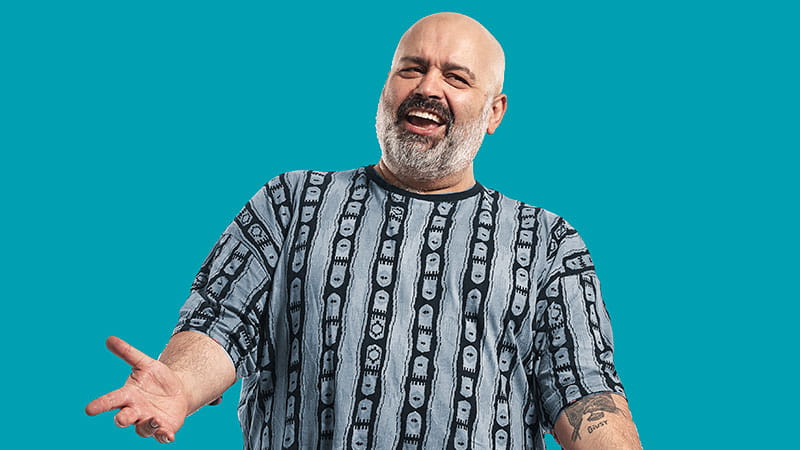 Man smiling with arm raised