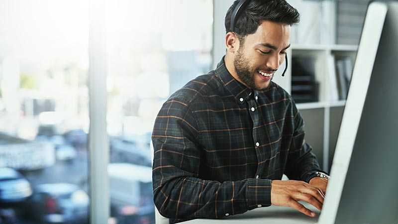 Man with headset on computer