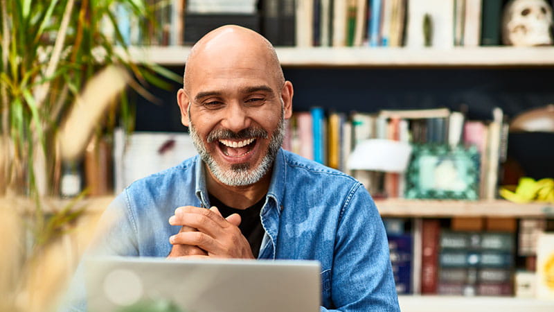 Smiling man at laptop