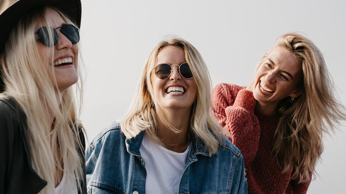 Three young women laughing
