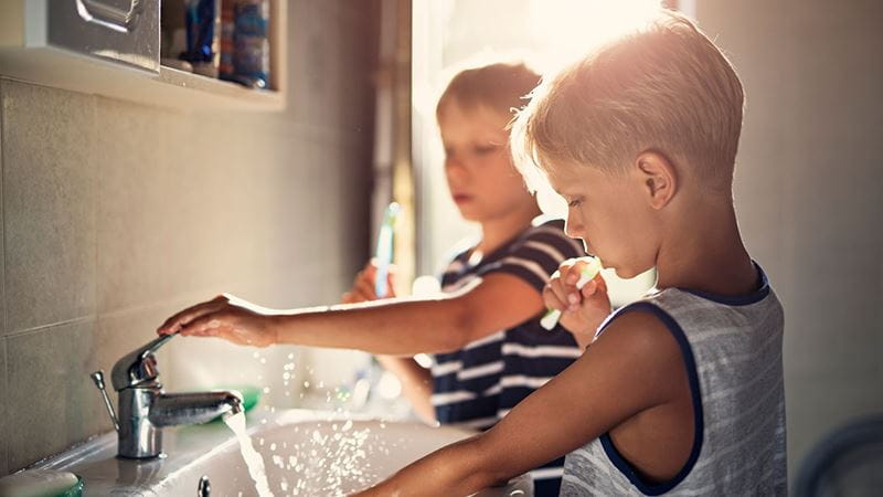 Boys brushing their teeth in the bathroom