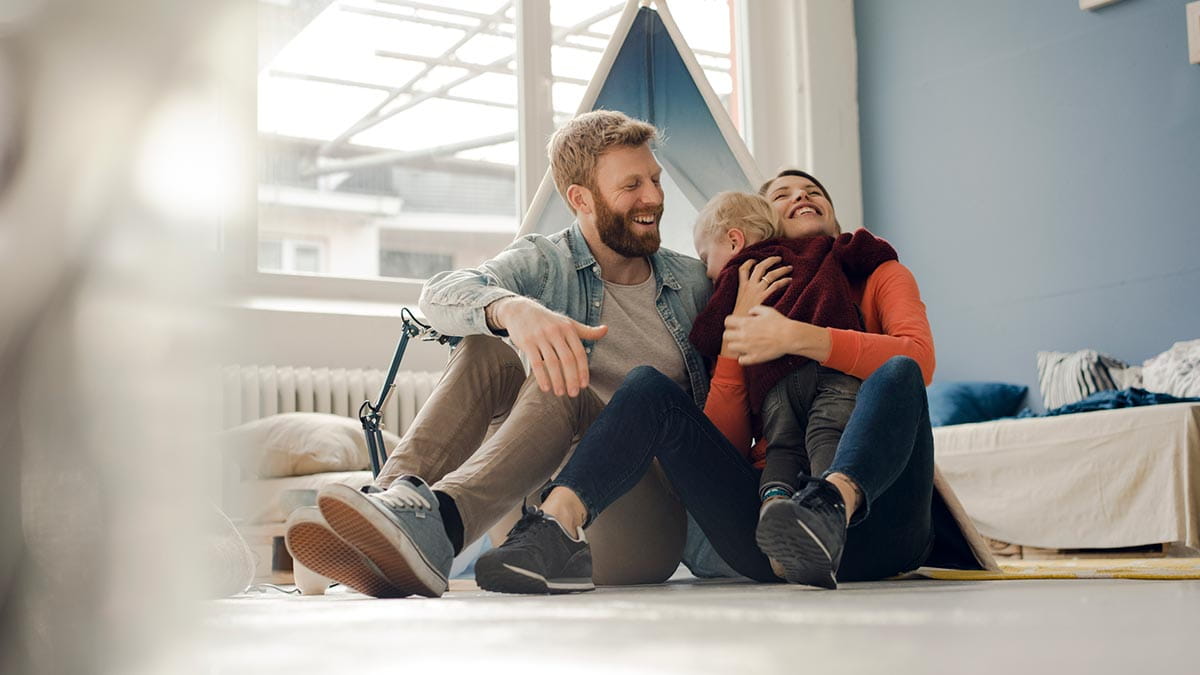 Family sitting on floor smiling