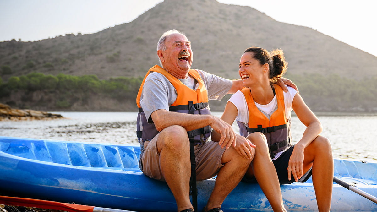 Father and daughter sitting together on a kayak