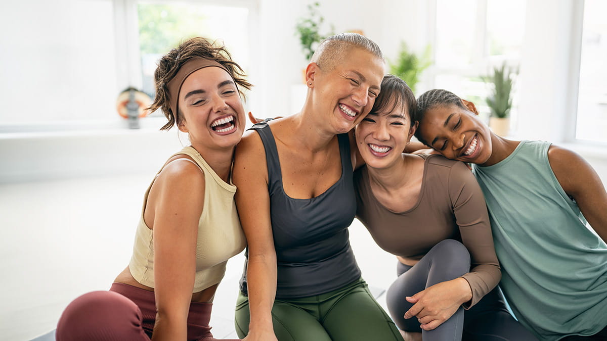 Four women smiling together