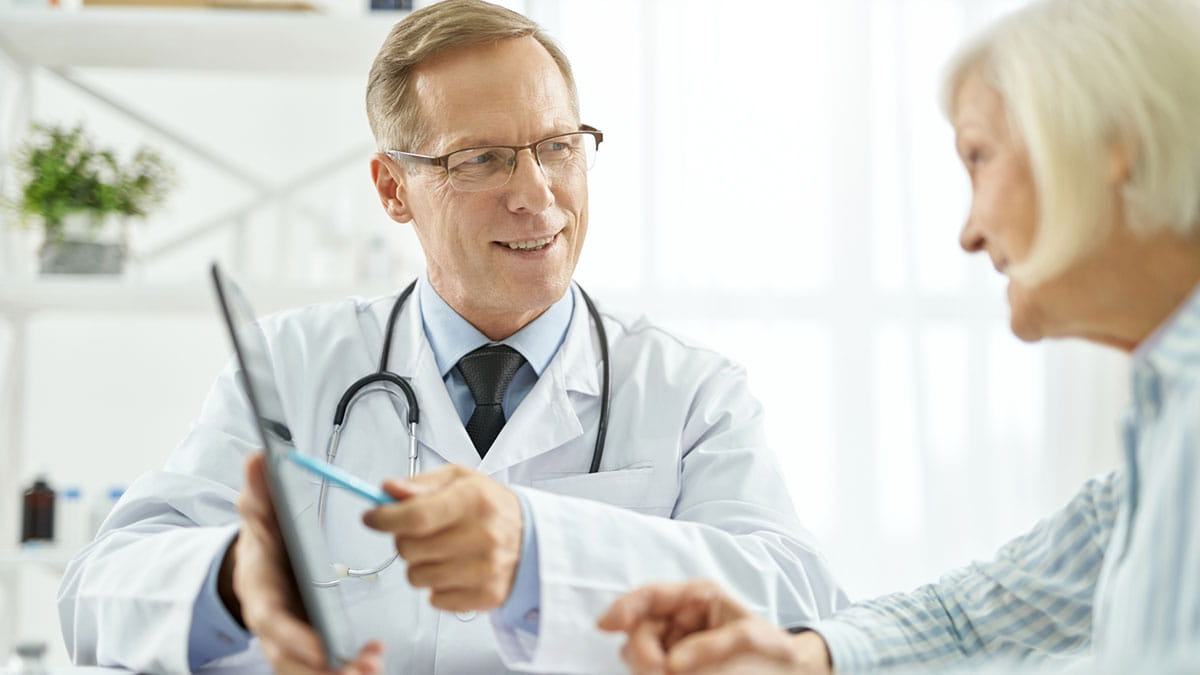 Doctor talking to elderly patient