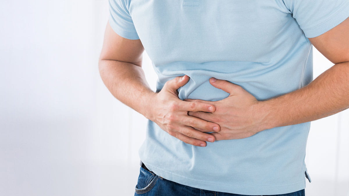 Man holding stomach