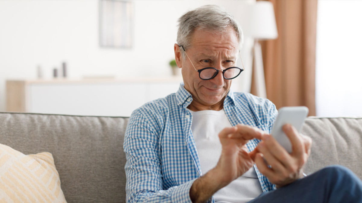 Older man looking at phone