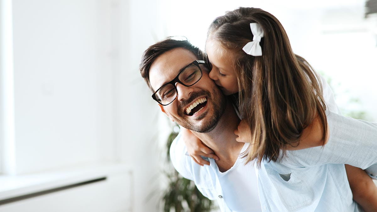 Father with toddler on back