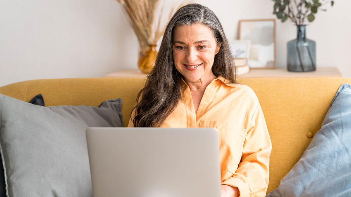 Smiling woman using a laptop