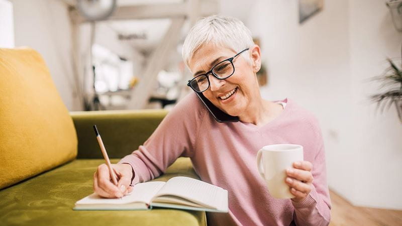 Woman smiling with notepad