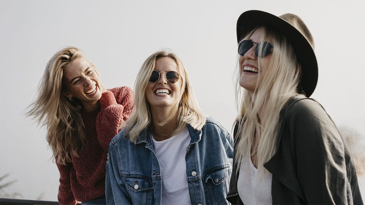 Three young adults laughing