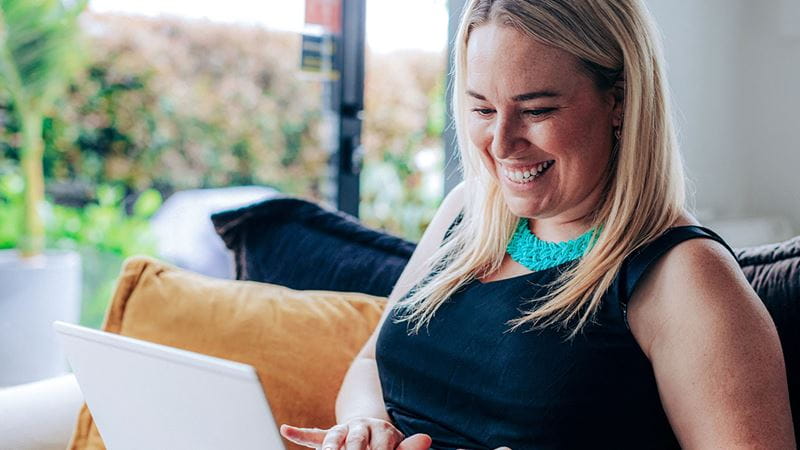 Woman smiling on laptop