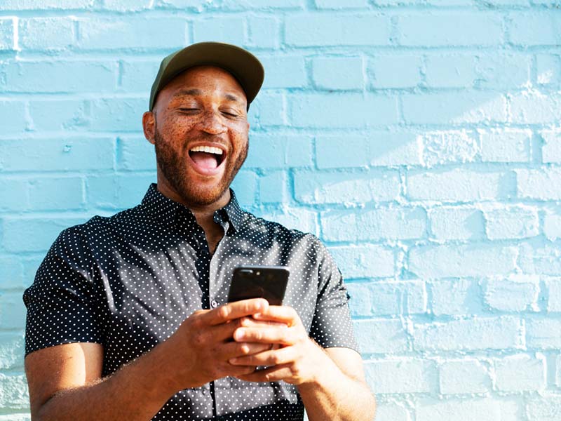 Man with phone smiling