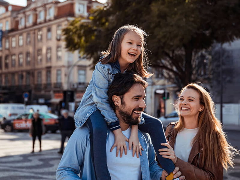 Man with partner and toddler on shoulders