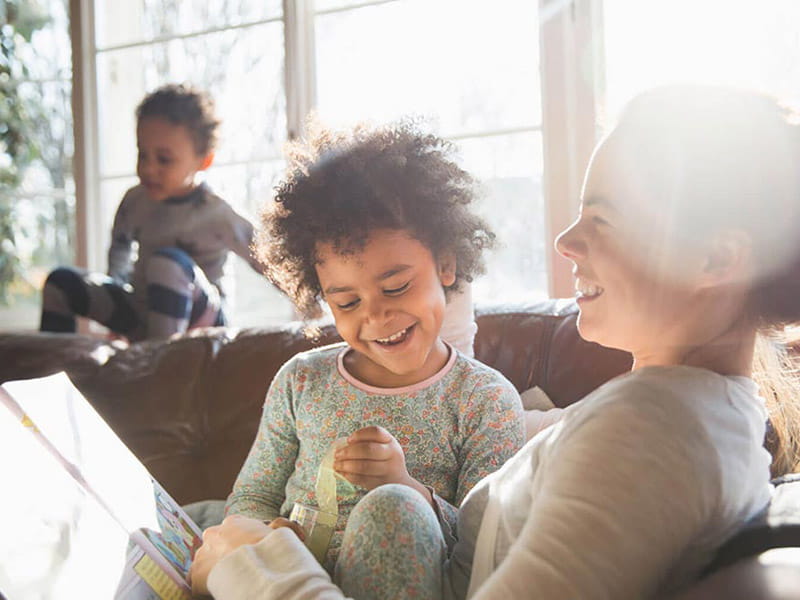 Young woman reading with toddler