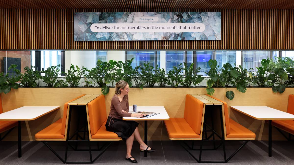 Female employee sitting in a booth at the HBF head office