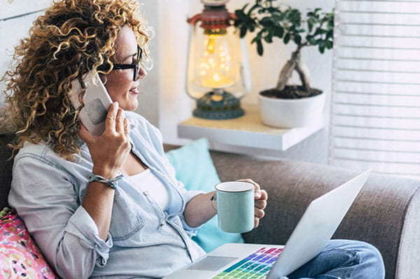 Woman drinking a coffee on her phone