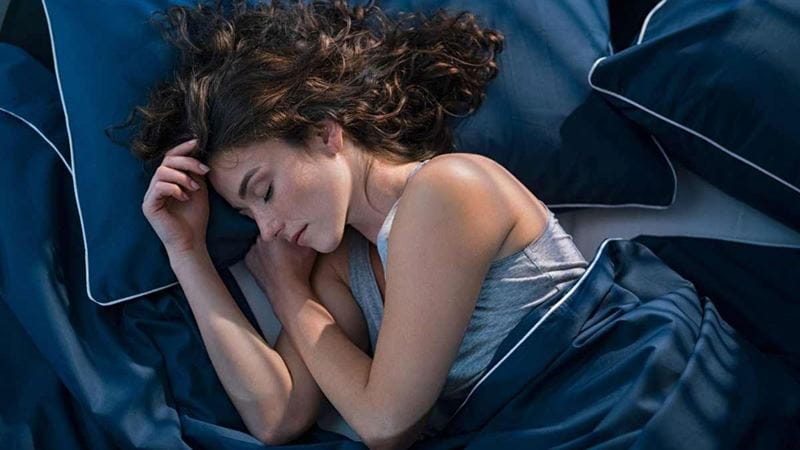 10 ways to get a better night’s sleep Woman sleeping in bed
