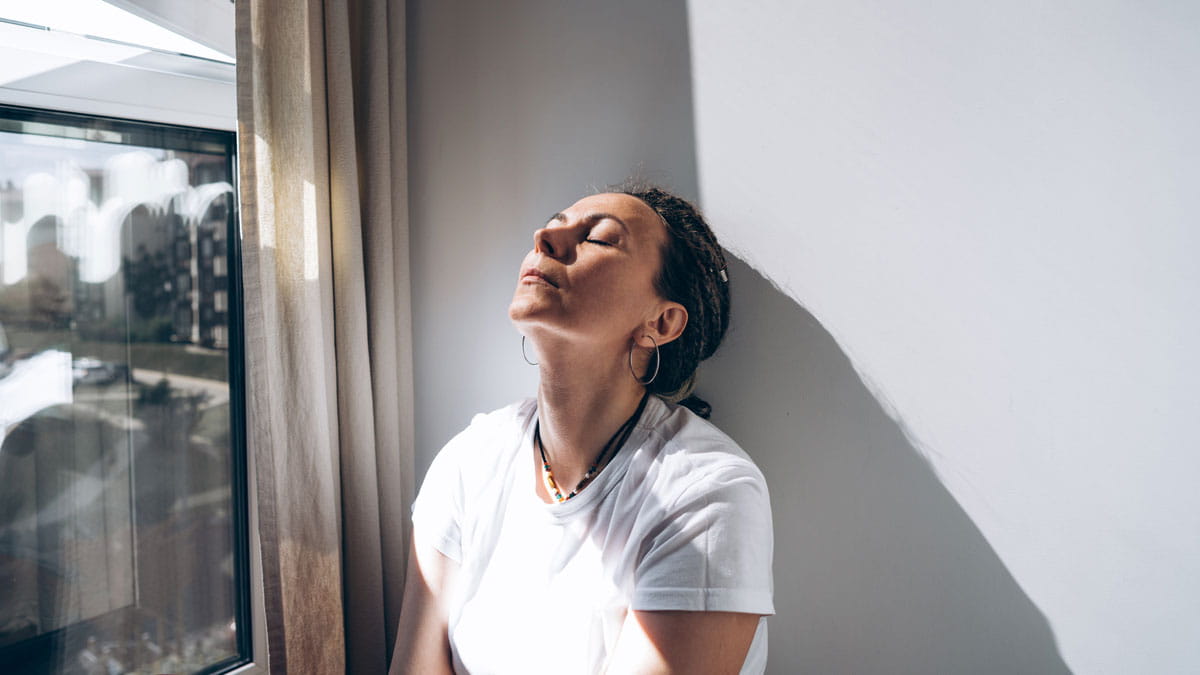 A stressed woman by the window