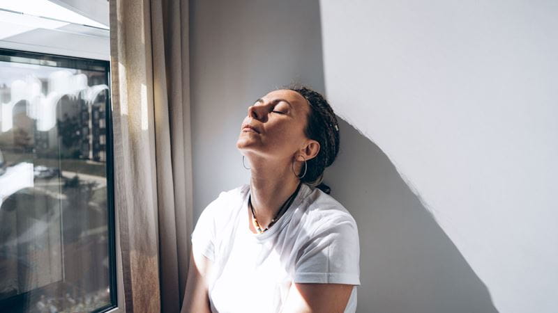 A stressed woman by the window