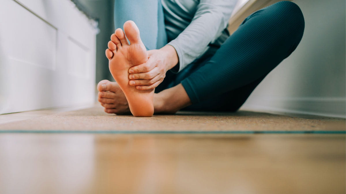 Person holding their foot