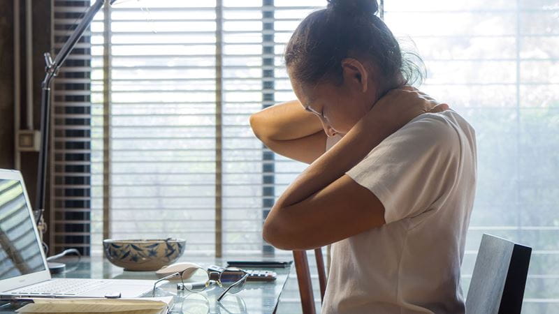 Woman holding her neck