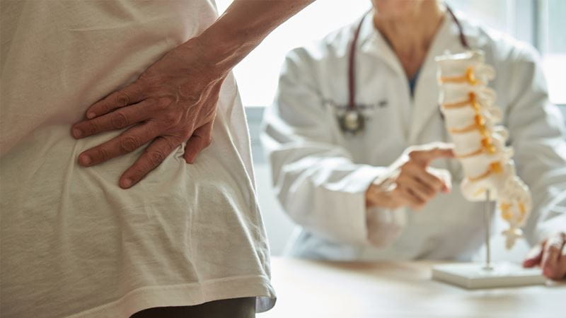 Patient holding their back