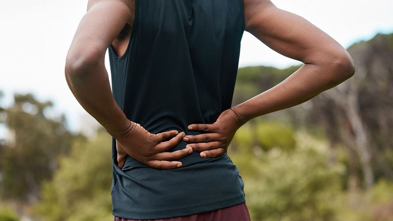 Man holding lower back in pain