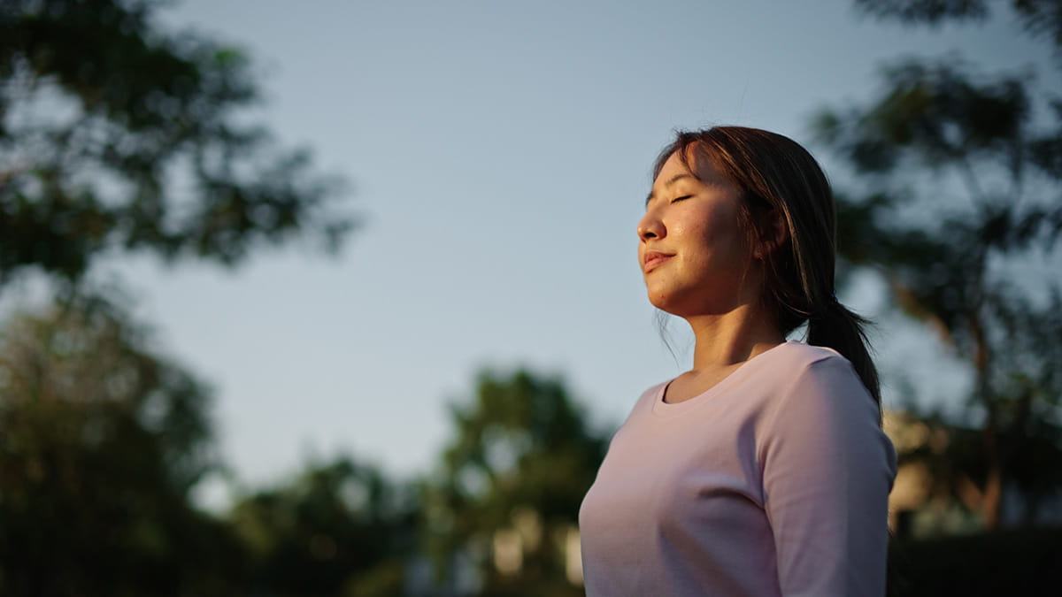 Woman breathing deeply with eyes closed
