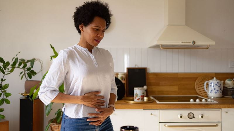 Woman clutching at stomach