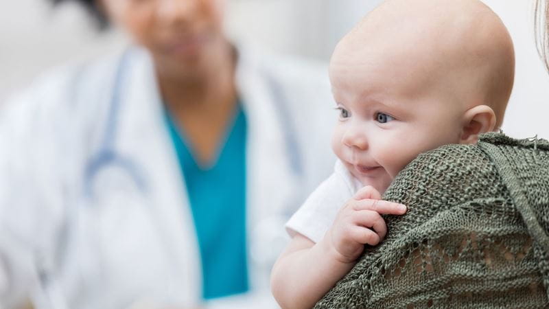 Woman taking her baby to a 6 week health check