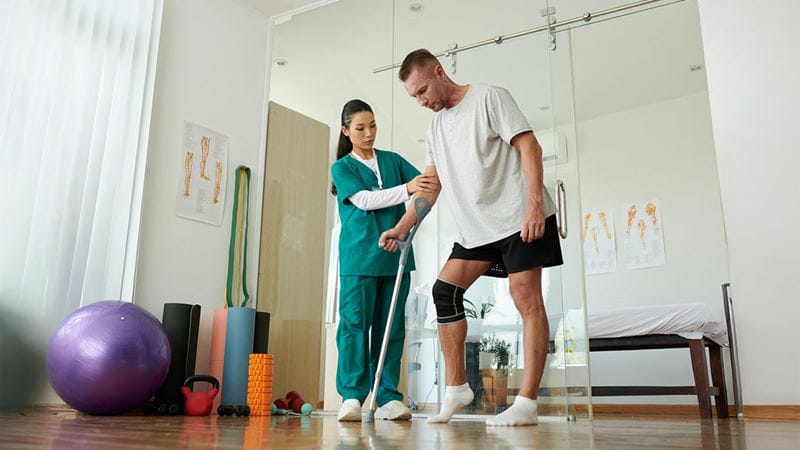 Man being assisted with walking