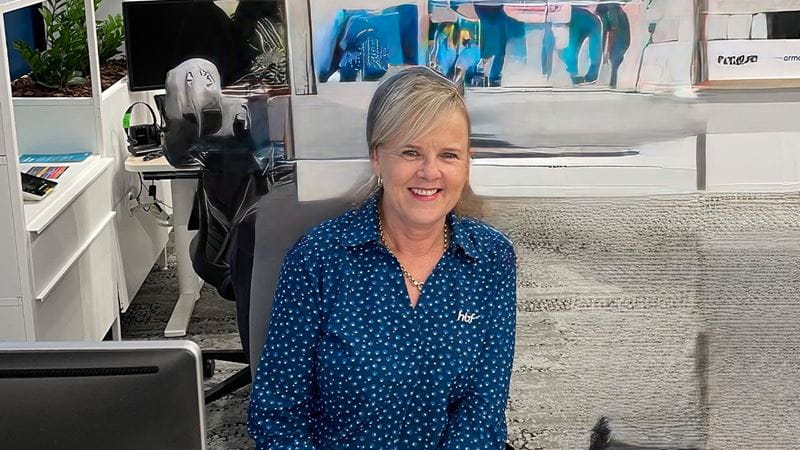 HBF employee seated at a desk in an office workspace.